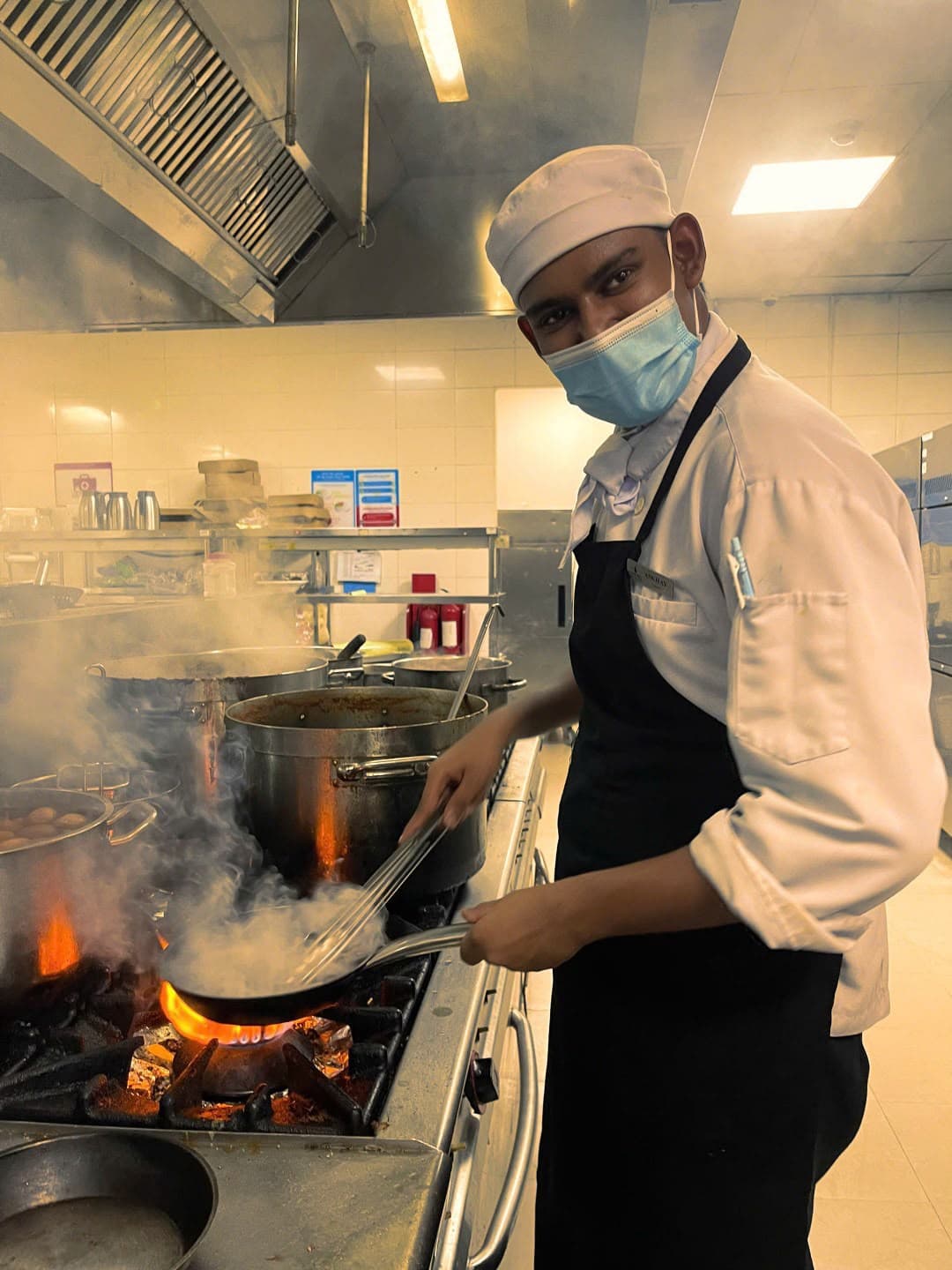 Hospitality student gaining culinary experience in a professional kitchen
